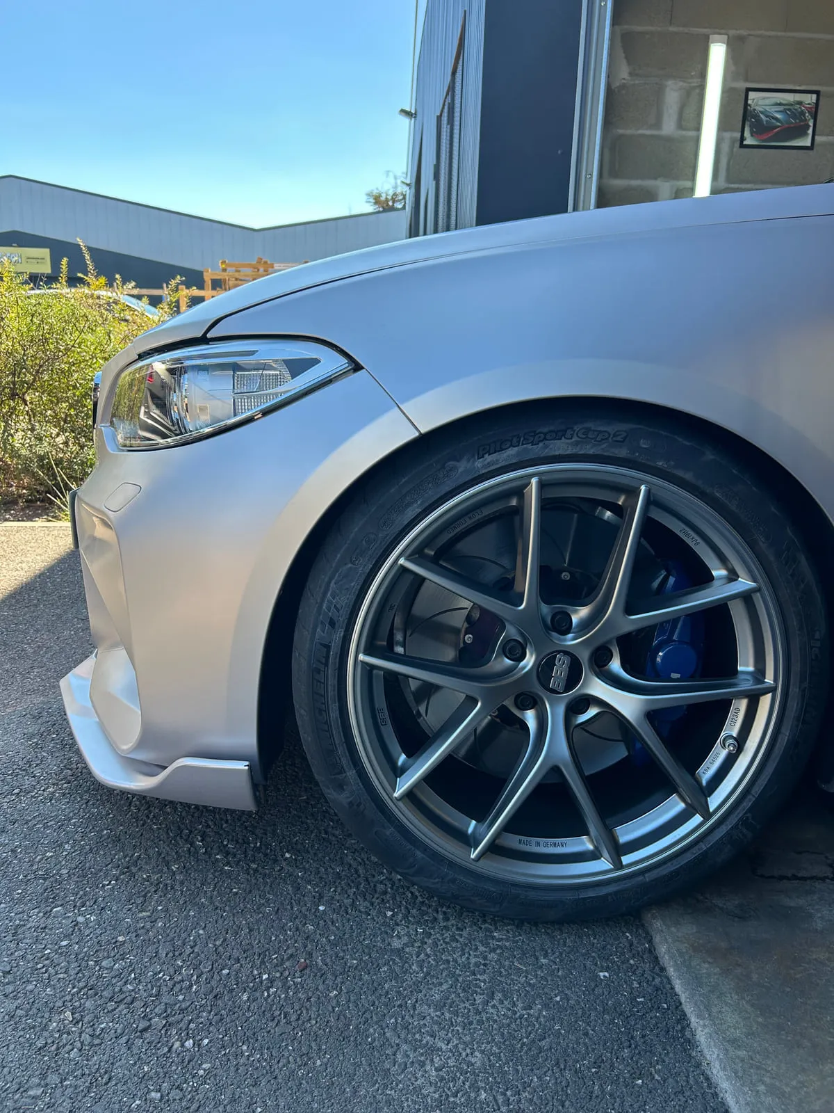 Roue avant d'une BMW gris mat : jante BBS grise à branches fines, étrier bleu, pneu Michelin